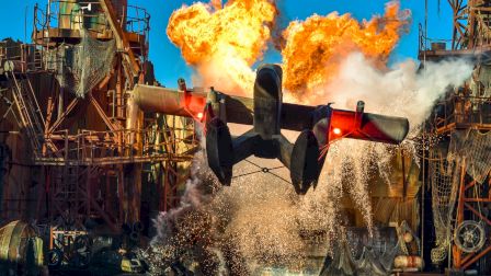 A seaplane flies over water with dramatic explosions and splashes in an industrial, action-packed scene.