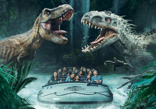 Two dinosaurs face off near a river raft filled with people at a theme park, creating an exciting and thrilling scene.